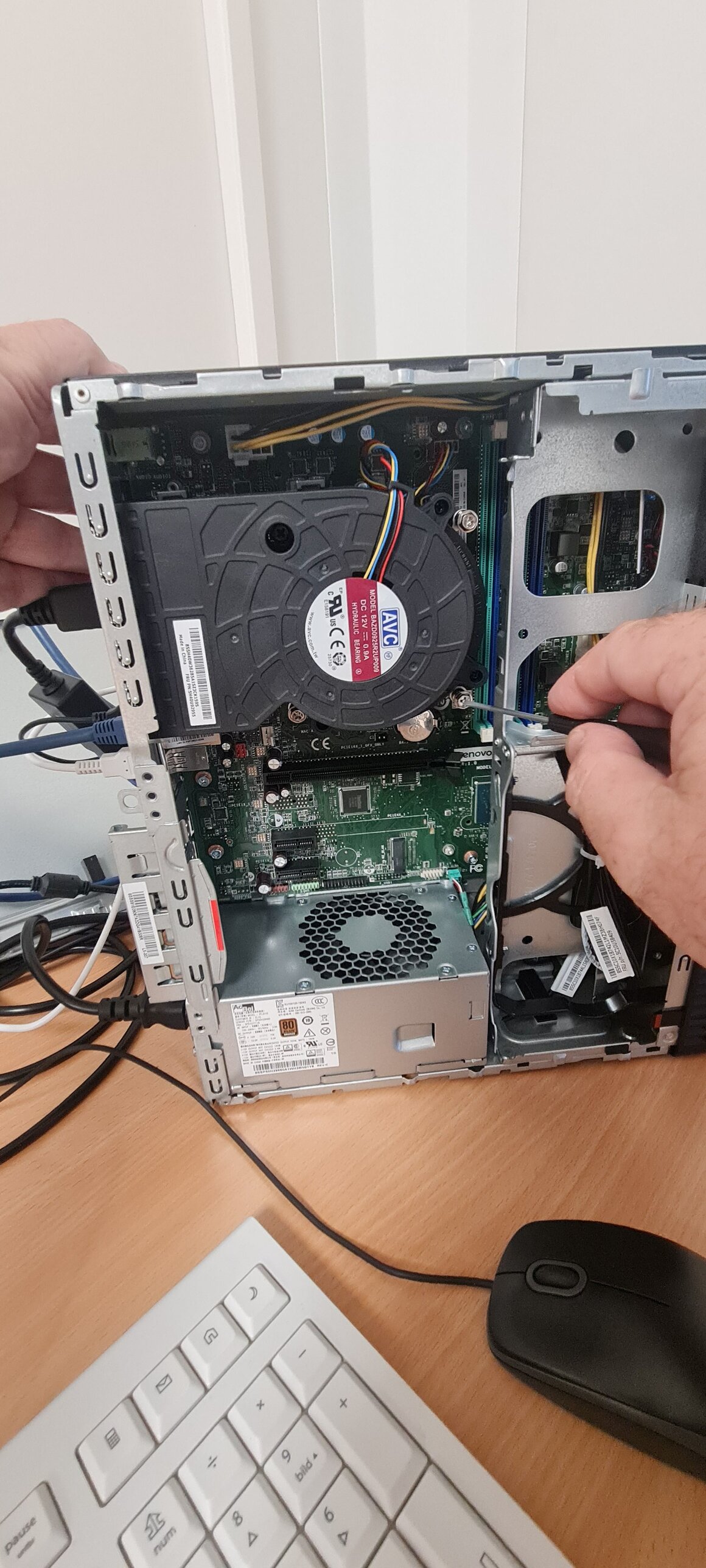 Techniker prüft einen Desktop-PC auf dem Schreibtisch